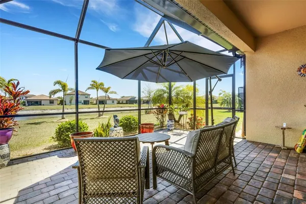 a patio with patio couch and umbrella