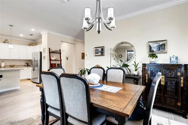 a dining room with furniture and chandelier