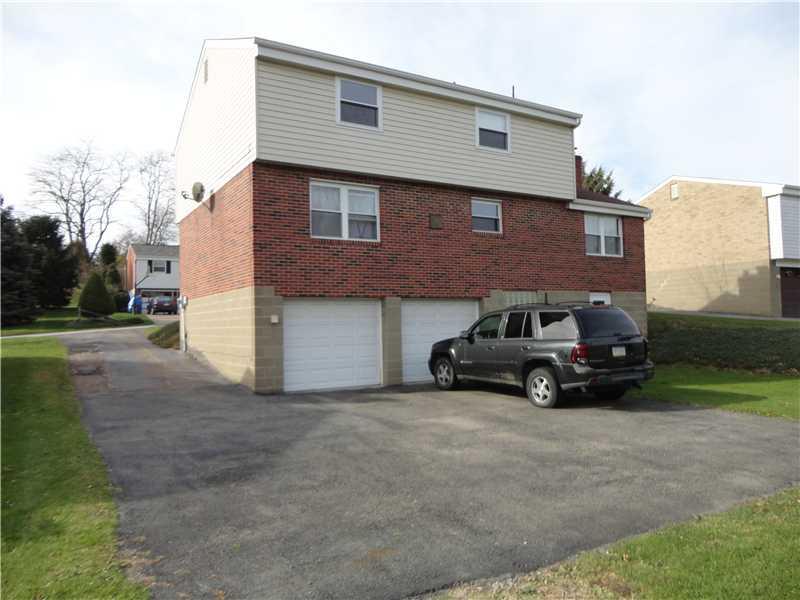 Exterior Back. Home is completely brick on the 1st level including the family room & masonary chimney.  Large paved driveway for easy turn around.
