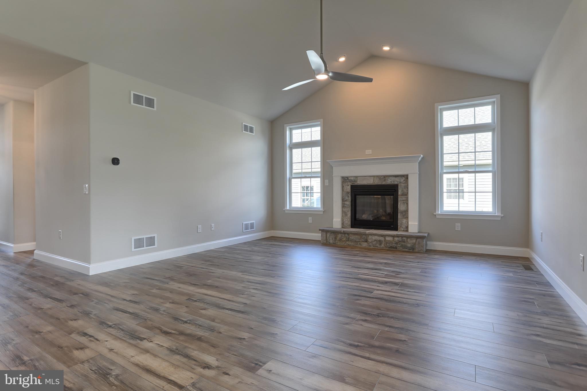 18 Rolling Meadow Road Lebanon, PA 17046 - Photo 13 of 35 an empty room with wooden floor fireplace and windows