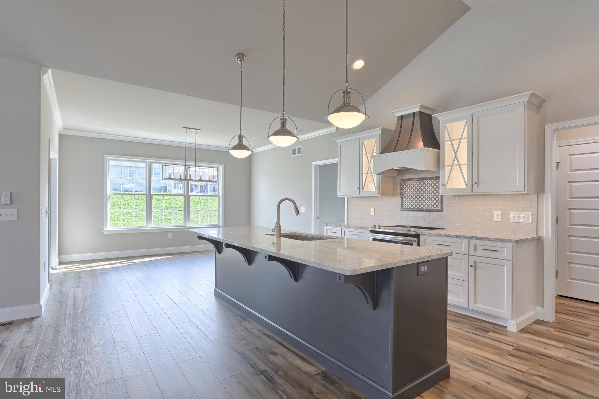 18 Rolling Meadow Road Lebanon, PA 17046 - Photo 16 of 35 a kitchen with stainless steel appliances granite countertop a sink a stove a refrigerator and island with wooden floor