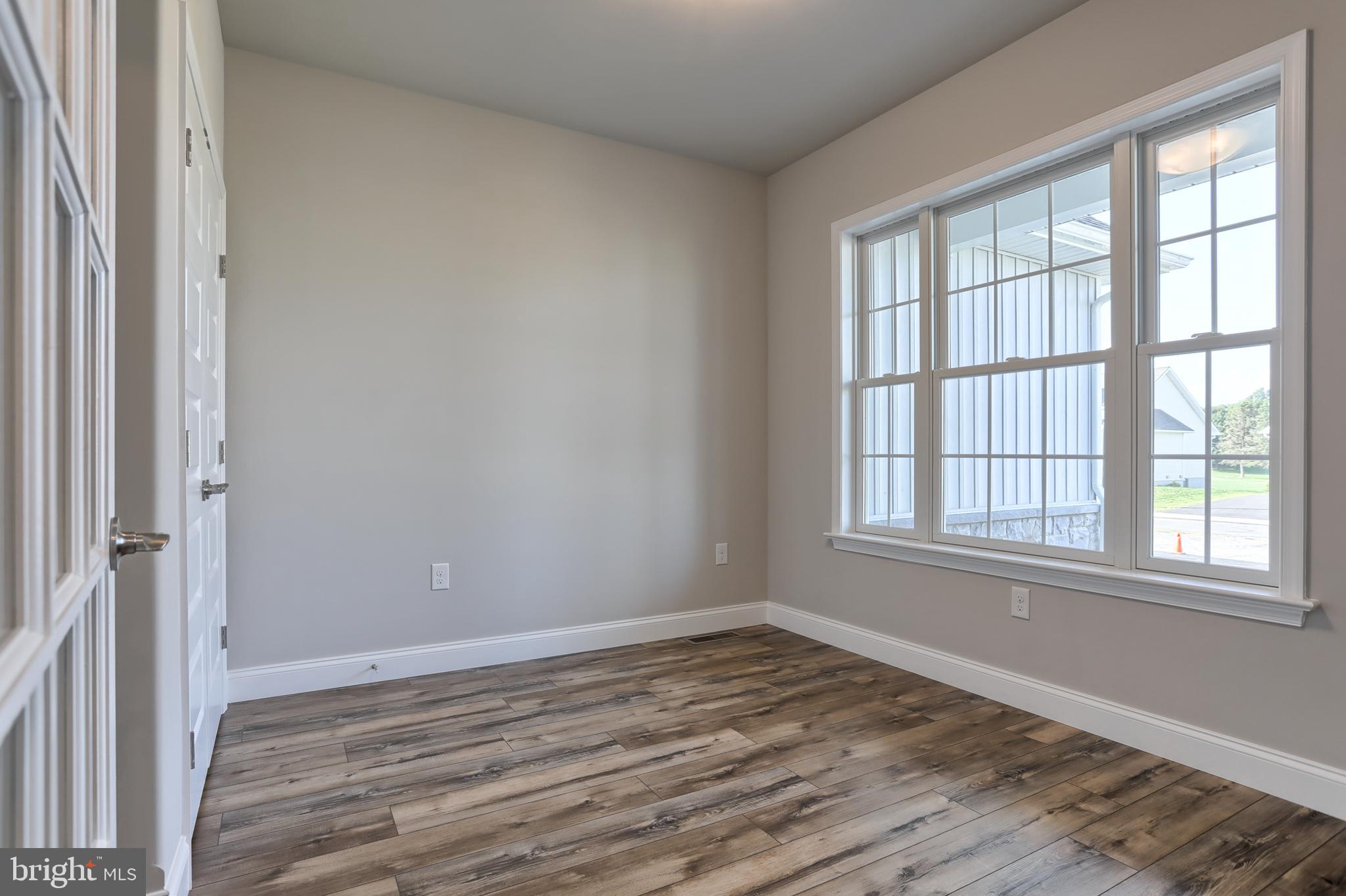 18 Rolling Meadow Road Lebanon, PA 17046 - Photo 4 of 35 an empty room with wooden floor and windows