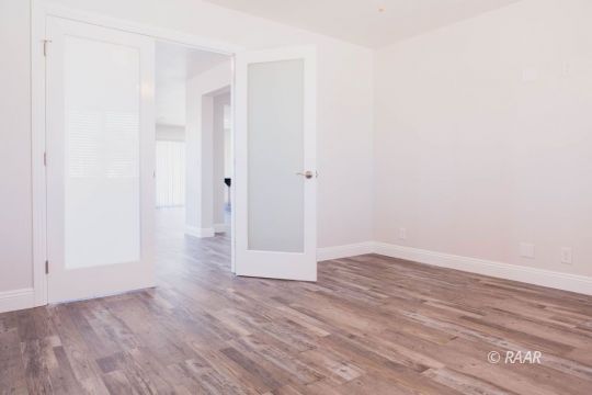 909 West Wasp Avenue Ridgecrest, CA 93555 - Photo 16 of 33 a view of an empty room with wooden floor