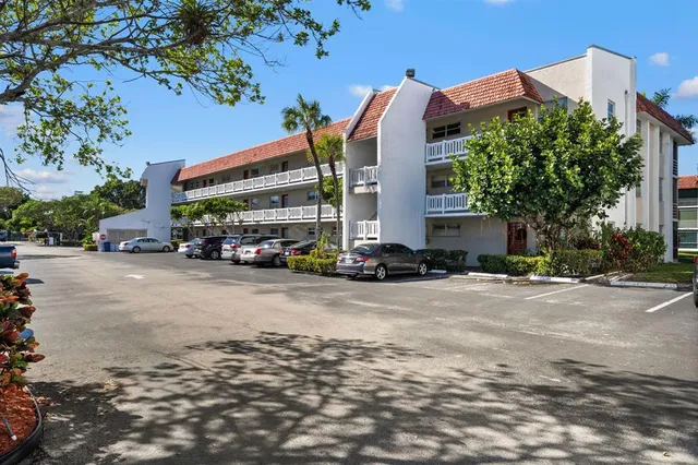 a front view of a building with trees