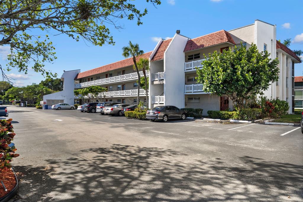 a front view of a building with trees