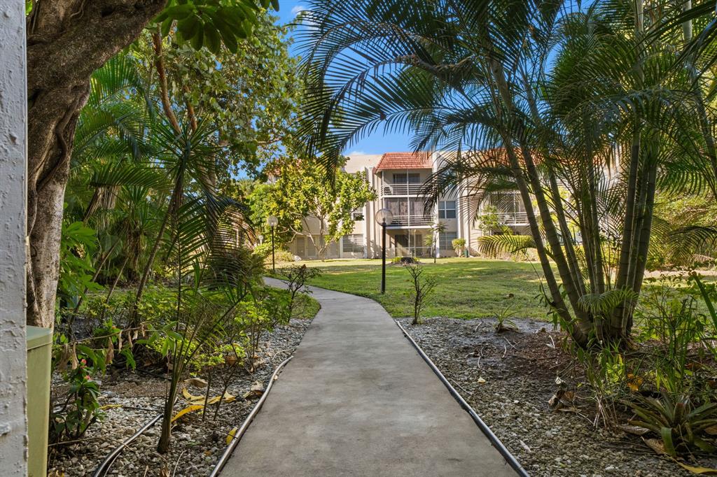 3511 Inverrary Drive, Unit 208 Lauderhill, FL 33319 - Photo 12 of 23 a green field with some trees in front of it