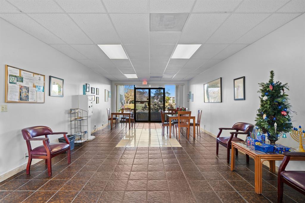 3511 Inverrary Drive, Unit 208 Lauderhill, FL 33319 - Photo 18 of 23 a living room with furniture a dining table and a potted plant