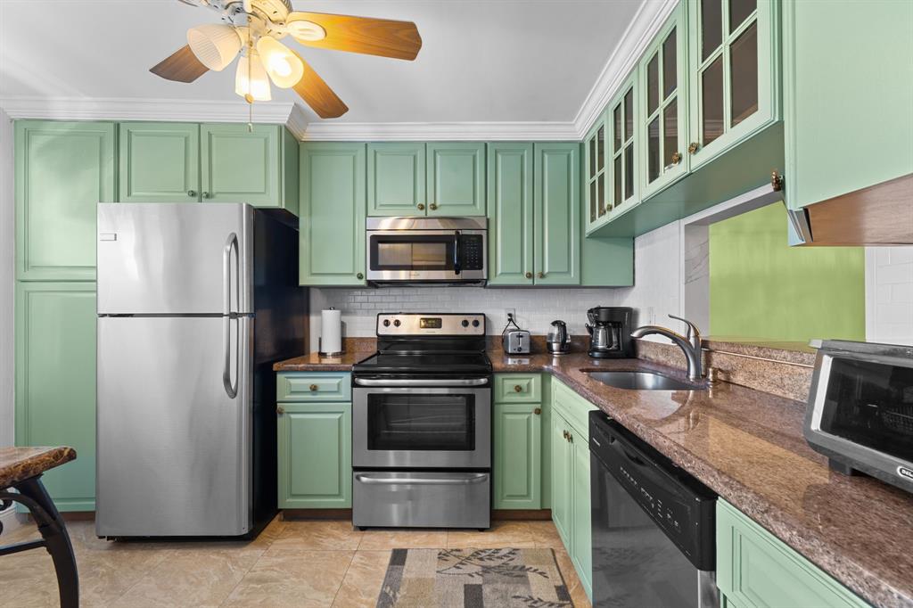 3511 Inverrary Drive, Unit 208 Lauderhill, FL 33319 - Photo 2 of 23 a kitchen with stainless steel appliances granite countertop a refrigerator a stove a sink and a microwave