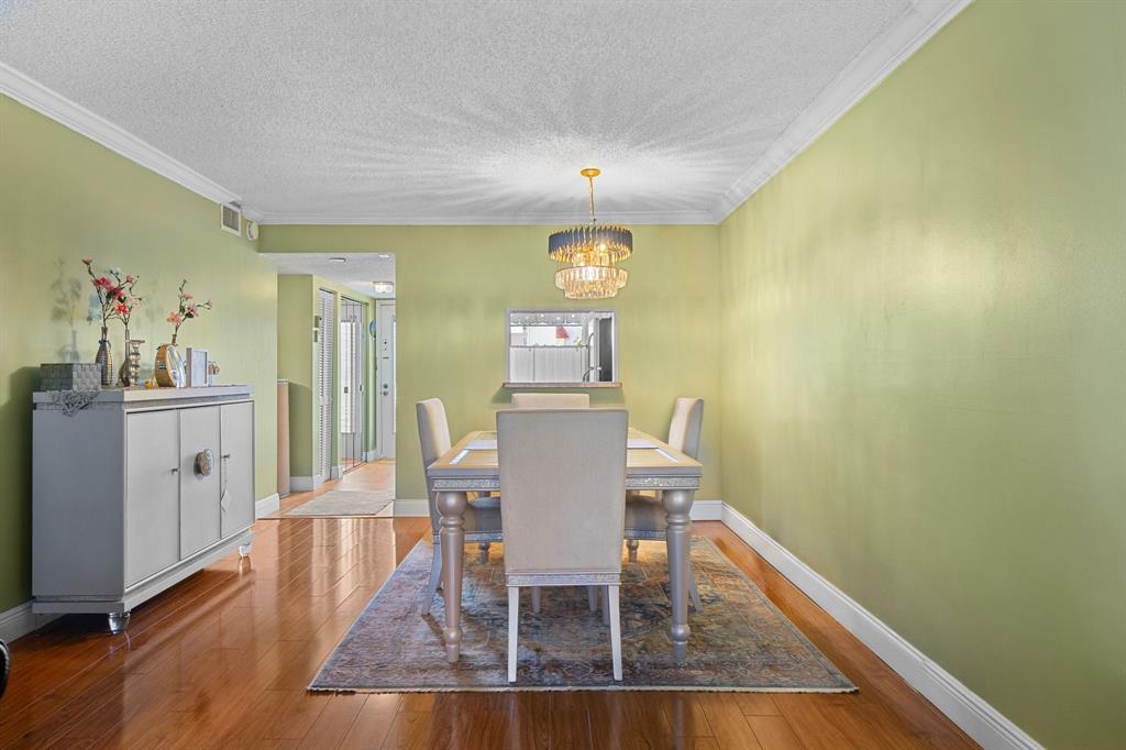 3511 Inverrary Drive, Unit 208 Lauderhill, FL 33319 - Photo 5 of 23 a view of a dining room with furniture and wooden floor