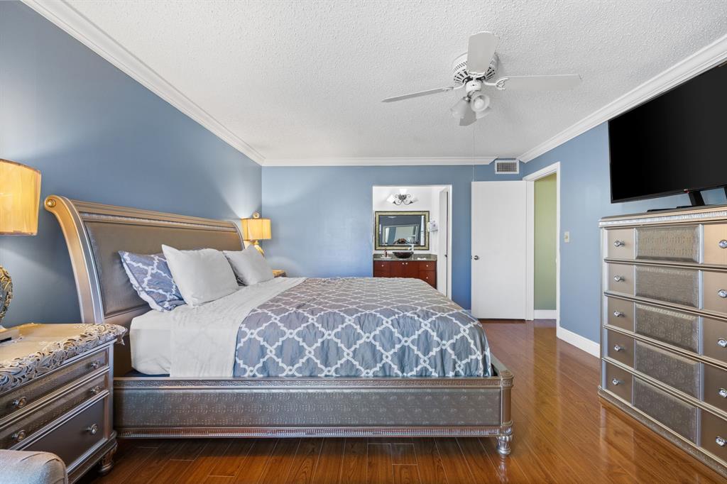 3511 Inverrary Drive, Unit 208 Lauderhill, FL 33319 - Photo 7 of 23 a bedroom with a large bed and a flat screen tv