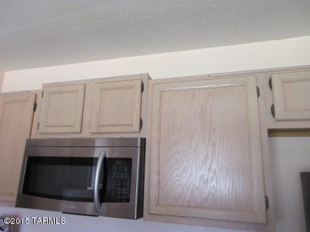 876 Calle Zapotec Rio Rico, AZ 85648 - Photo 8 of 29 a room with a fireplace and cabinets