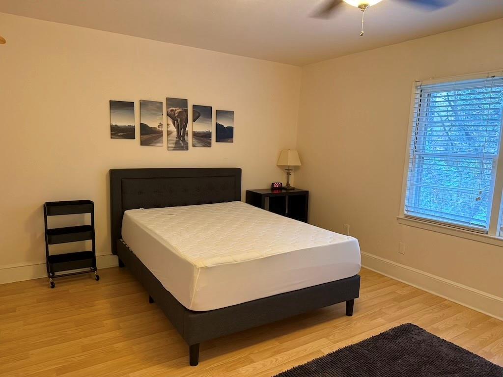 2035 Lyle Avenue, Unit A College Park, GA 30337 - Photo 11 of 12 a bed sitting in a bedroom next to a window