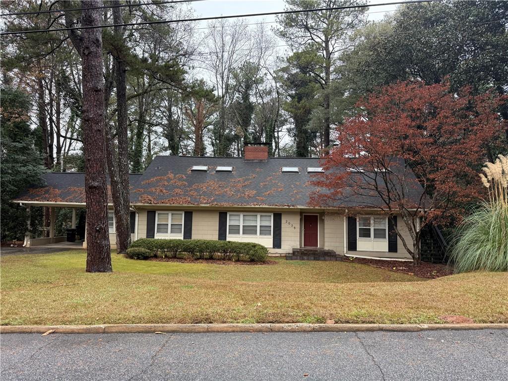 2035 Lyle Avenue, Unit A College Park, GA 30337 - Photo 3 of 12 a front view of a house with a yard and large tree