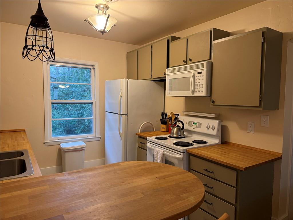 2035 Lyle Avenue, Unit A College Park, GA 30337 - Photo 6 of 12 a kitchen with stainless steel appliances a stove a refrigerator and a sink with wooden floor