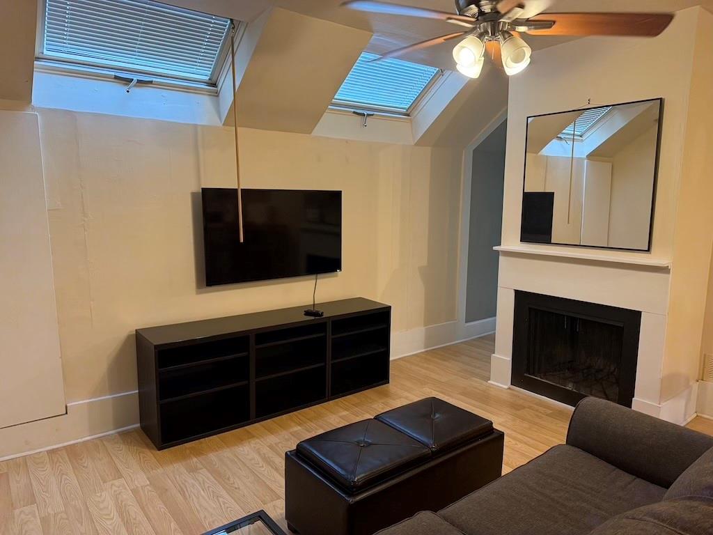 2035 Lyle Avenue, Unit A College Park, GA 30337 - Photo 7 of 12 a living room with furniture a flat screen tv and a fireplace