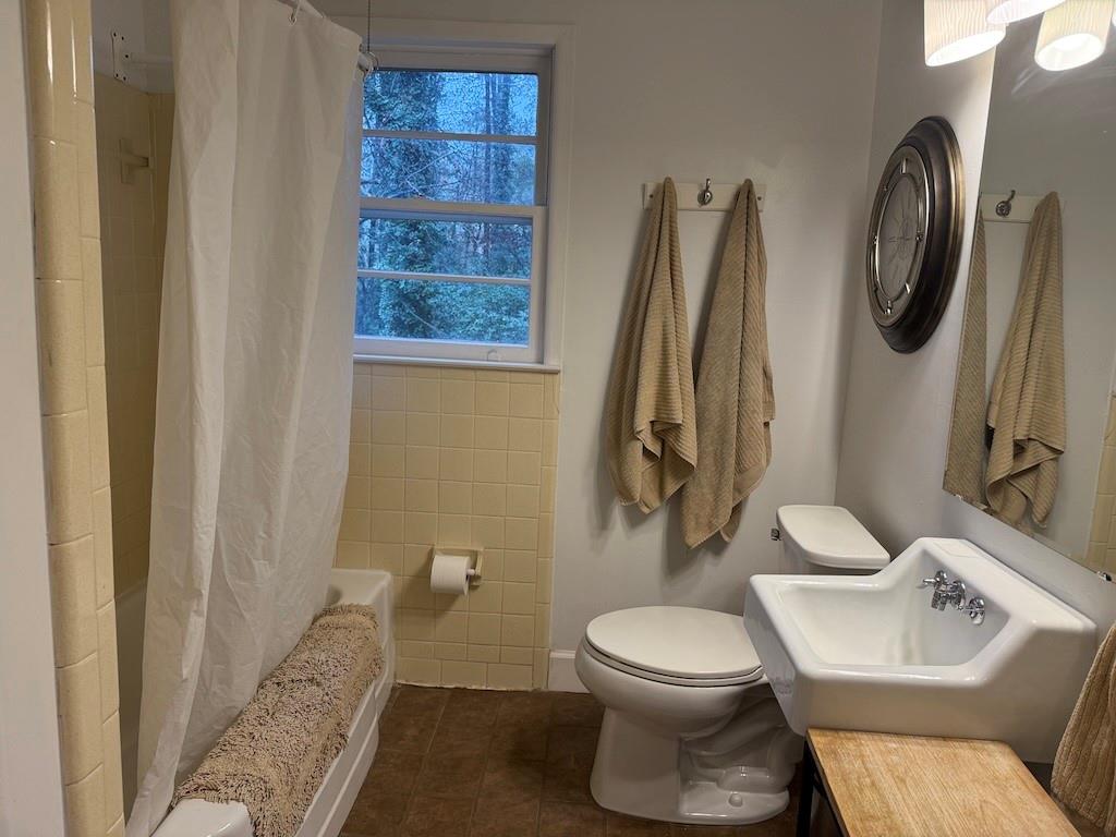 2035 Lyle Avenue, Unit A College Park, GA 30337 - Photo 10 of 12 a bathroom with a toilet sink and mirror