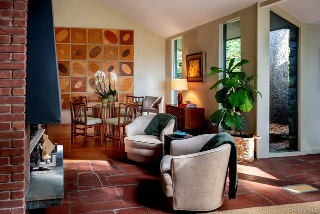 a living room with furniture and a potted plant