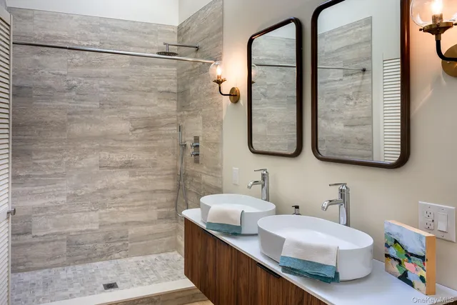 a bedroom with a bed and large windows