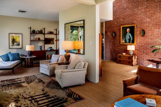 a living room with furniture wooden floor and a fireplace