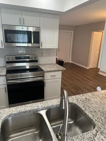 a kitchen with a refrigerator stove and microwave