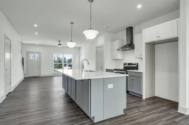 a bathroom with a granite countertop sink a large mirror and a shower