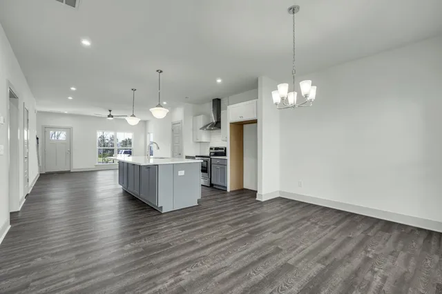 a spacious bathroom with a double vanity sink a mirror and a shower