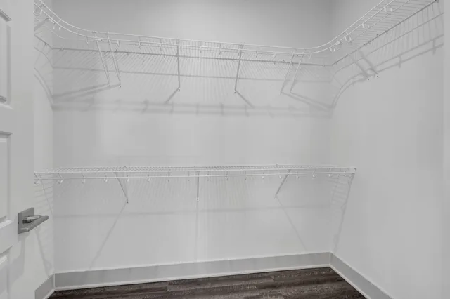 a view of an empty room and wooden floor