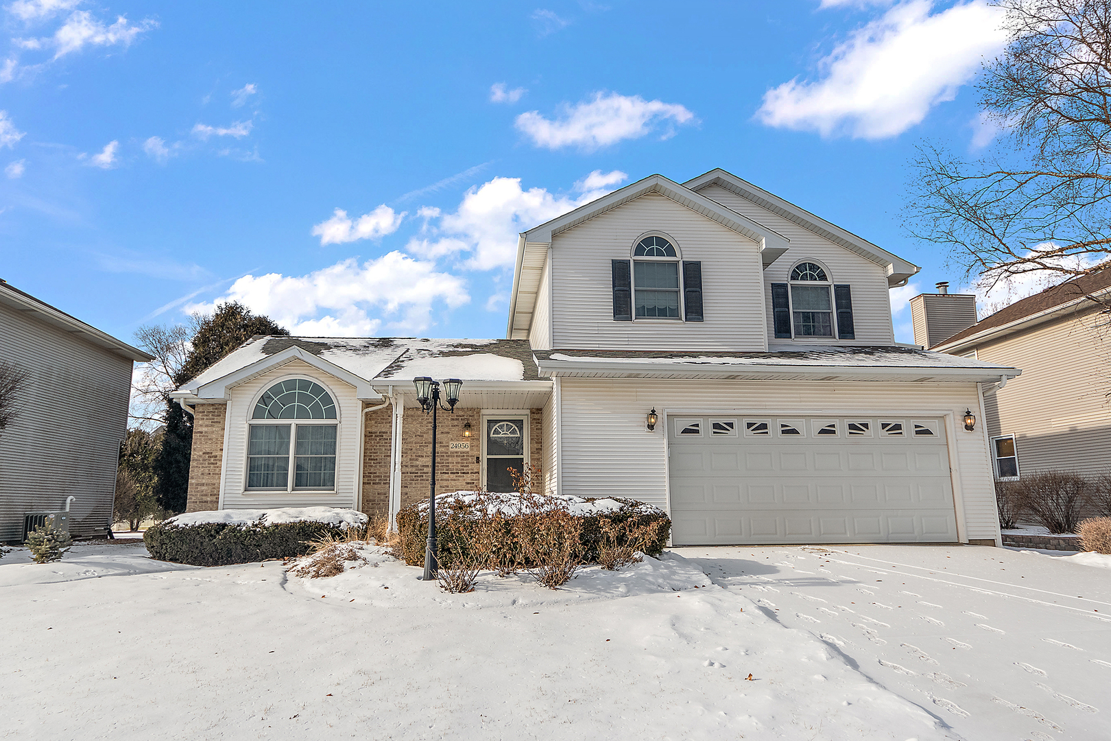 a front view of a house with a yard and garage