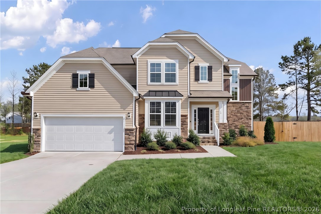 18 Two Belles Court Angier, NC 27501 - Photo 1 of 39 a front view of a house with a yard and garage