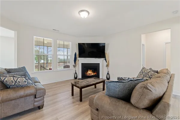 a living room with furniture and a fireplace