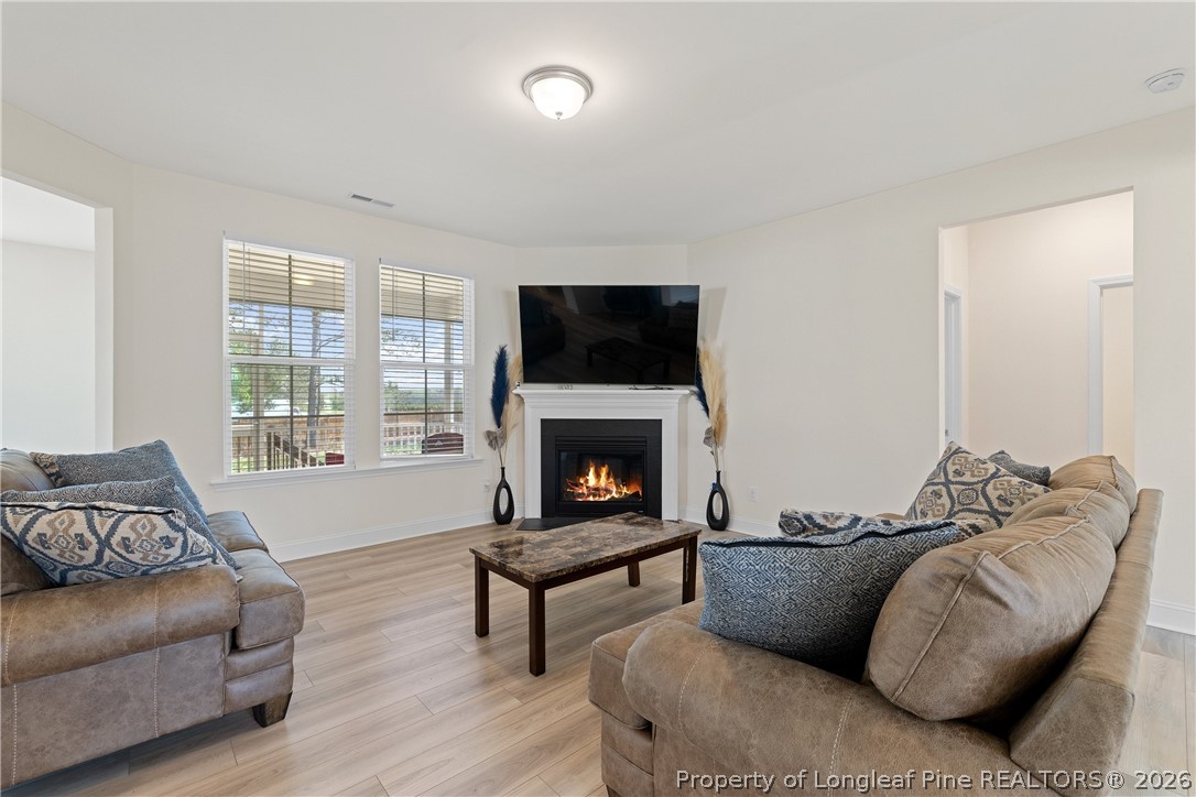 18 Two Belles Court Angier, NC 27501 - Photo 14 of 39 a living room with furniture and a fireplace