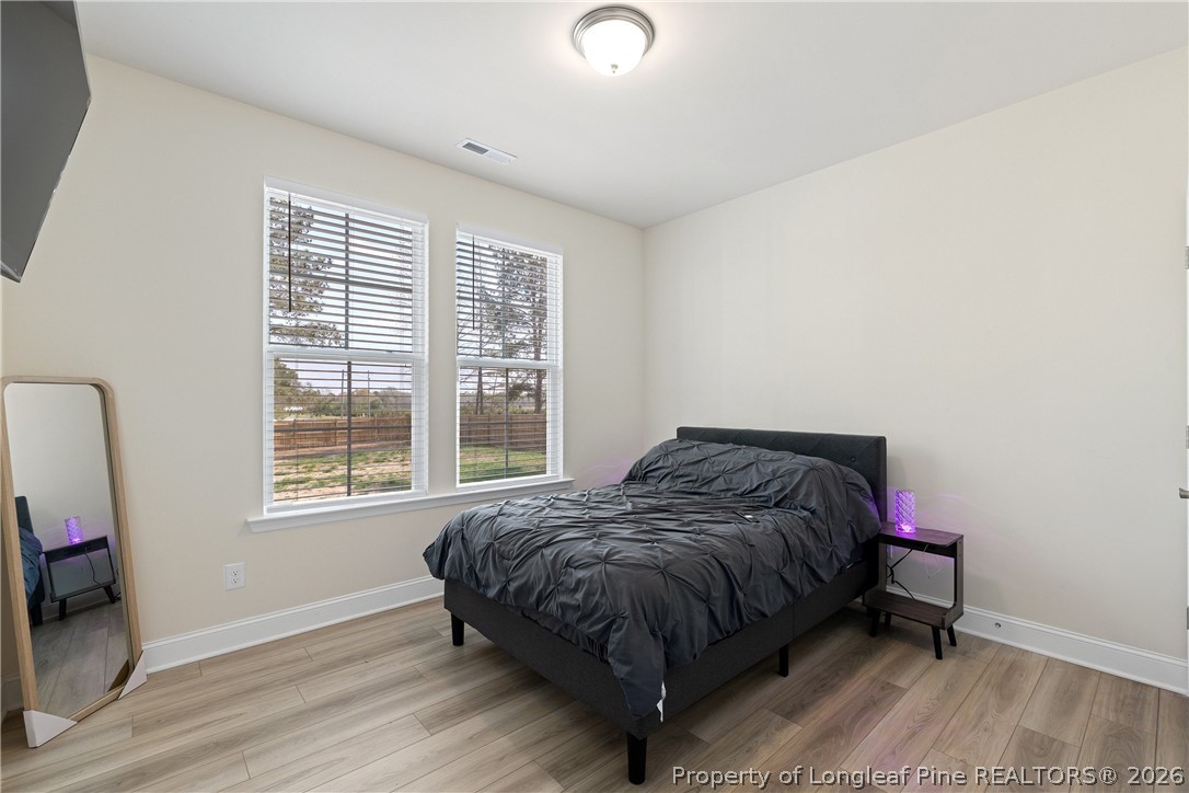 18 Two Belles Court Angier, NC 27501 - Photo 16 of 39 a bedroom with a bed and a window