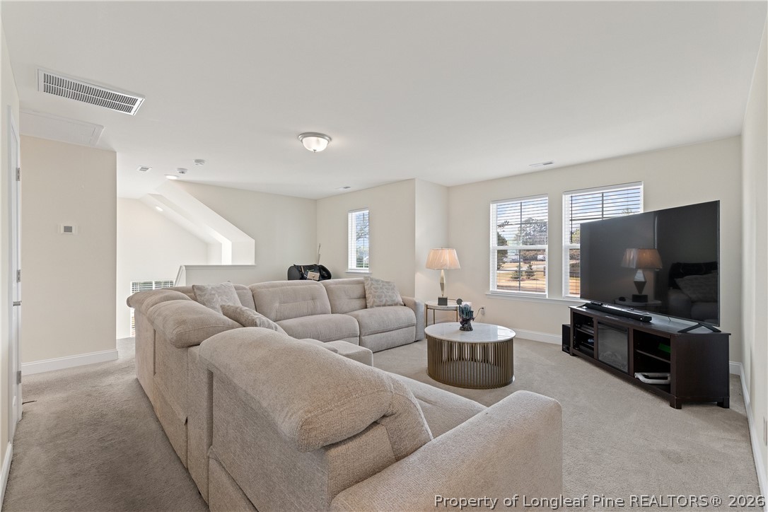 18 Two Belles Court Angier, NC 27501 - Photo 18 of 39 a living room with furniture and a flat screen tv