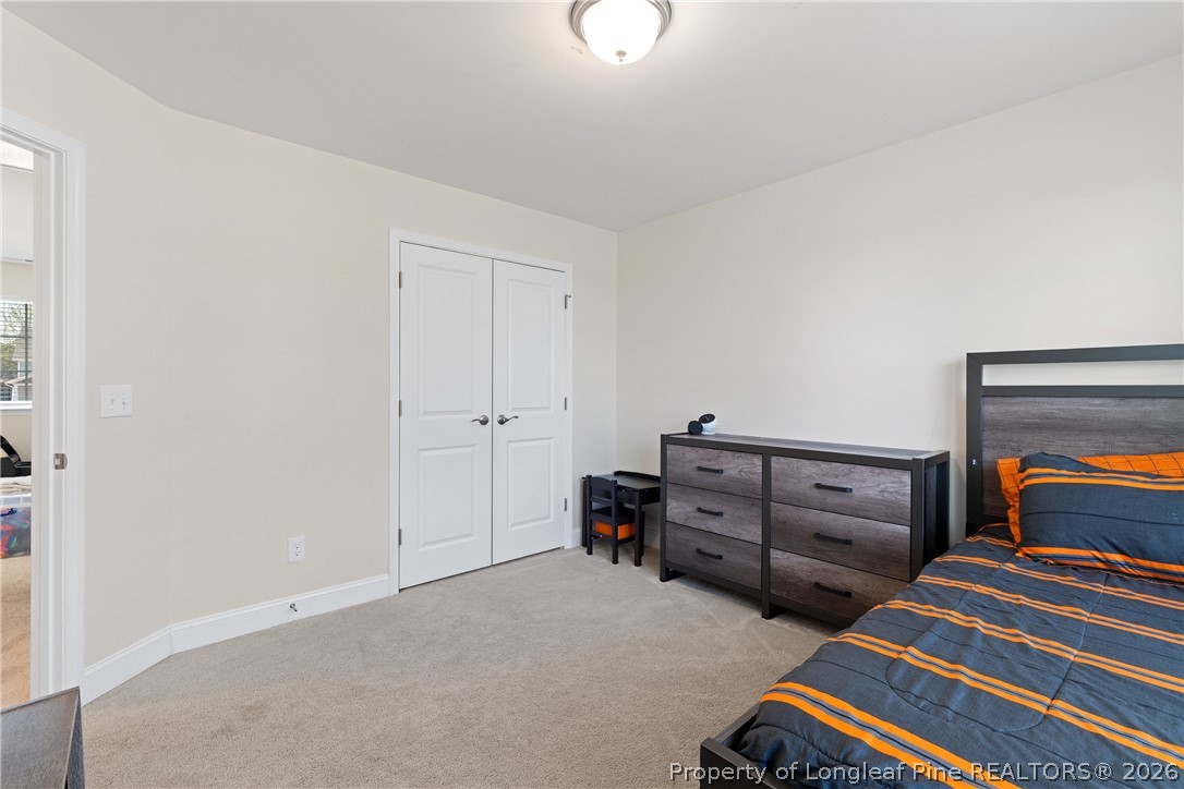 18 Two Belles Court Angier, NC 27501 - Photo 22 of 39 a bedroom with furniture and lamp