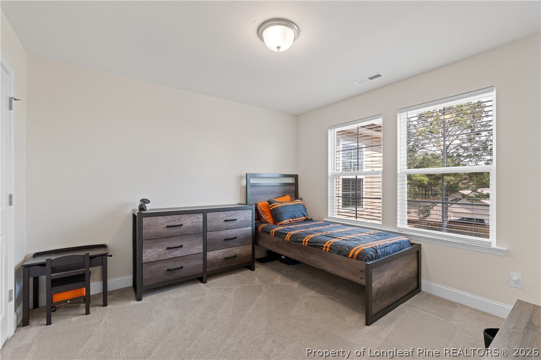 18 Two Belles Court Angier, NC 27501 - Photo 23 of 39 a bedroom with furniture and a window