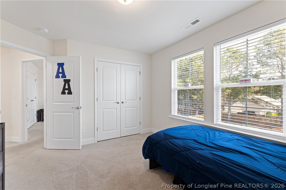 18 Two Belles Court Angier, NC 27501 - Photo 24 of 39 a living room with a large bed and a large window