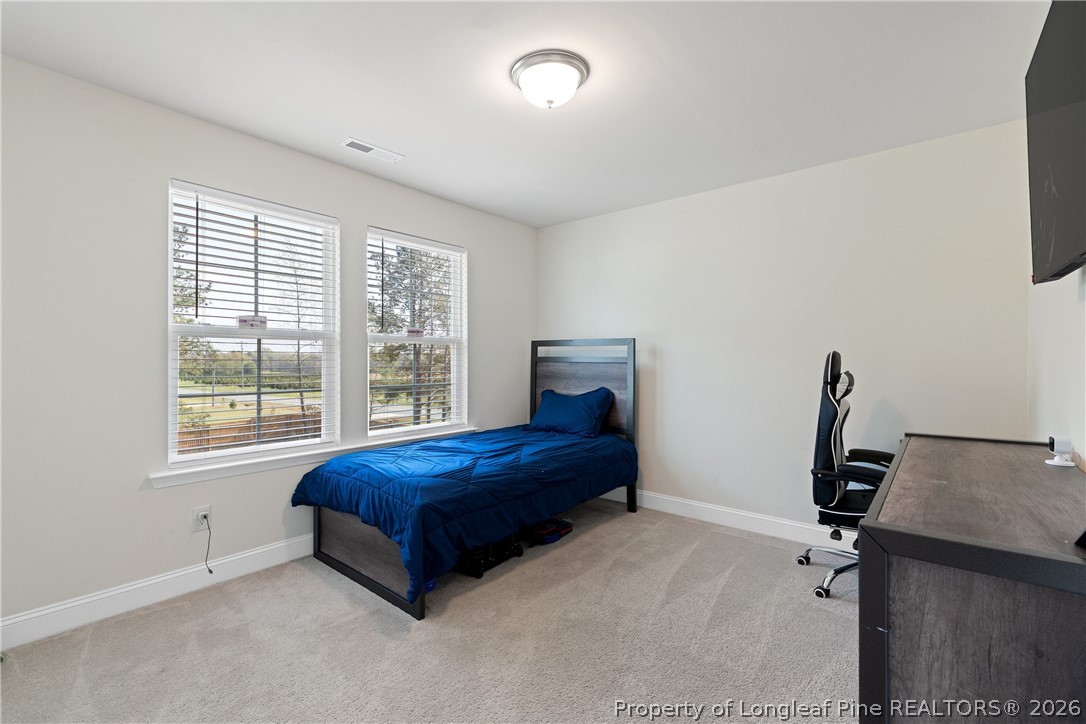 18 Two Belles Court Angier, NC 27501 - Photo 25 of 39 a living room with a bed furniture and a window