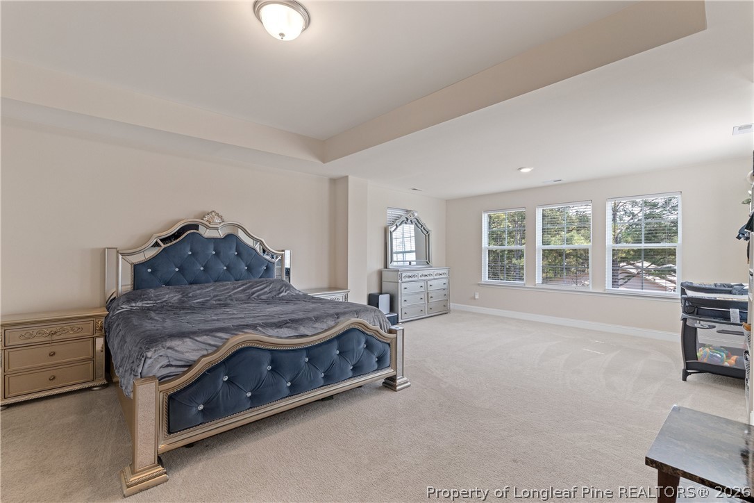 18 Two Belles Court Angier, NC 27501 - Photo 26 of 39 a spacious bedroom with a bed and large windows