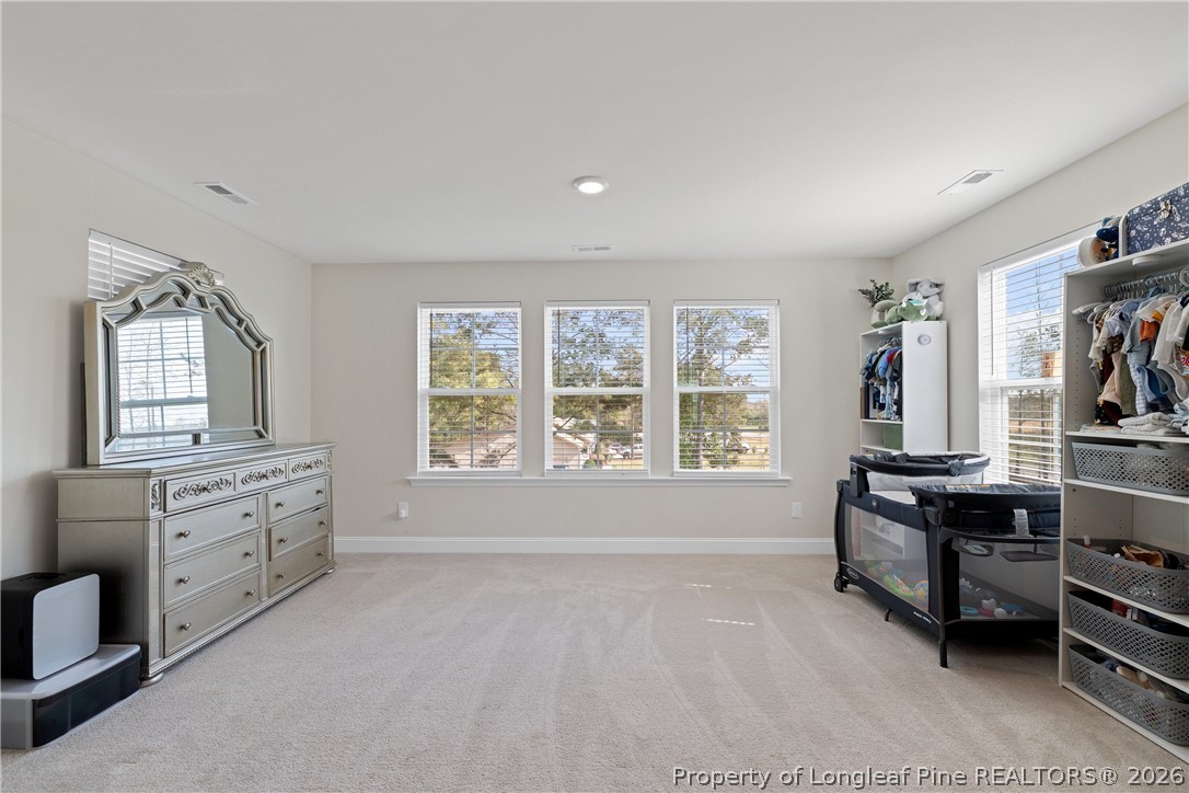 18 Two Belles Court Angier, NC 27501 - Photo 27 of 39 a spacious bedroom with a bed and furniture with window