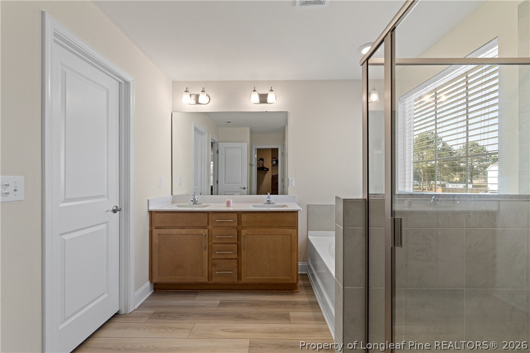18 Two Belles Court Angier, NC 27501 - Photo 29 of 39 a spacious bathroom with a mirror and a sink