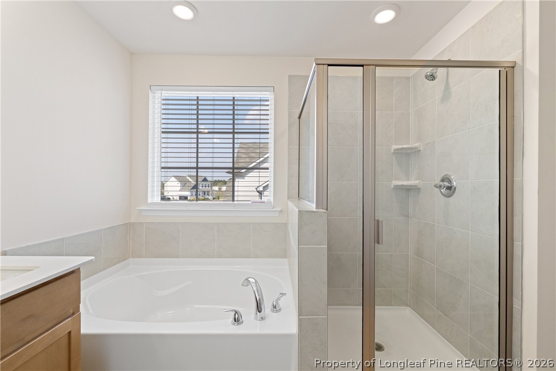 18 Two Belles Court Angier, NC 27501 - Photo 30 of 39 a bathroom with a bathtub and a shower