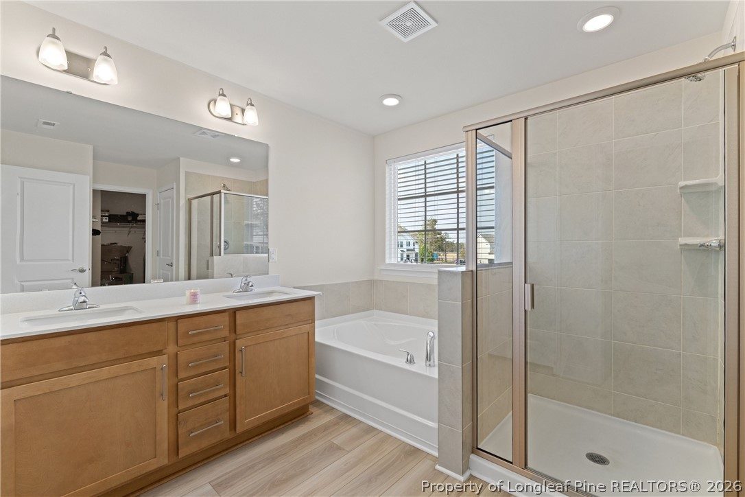 18 Two Belles Court Angier, NC 27501 - Photo 31 of 39 a bathroom with a tub sink shower and mirror