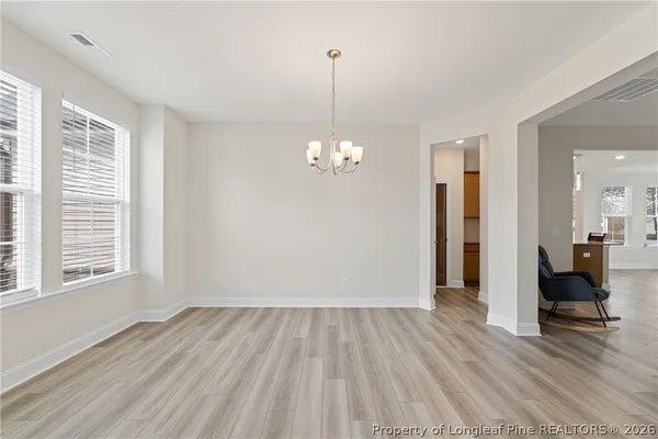 a view of a room with wooden floor and a window