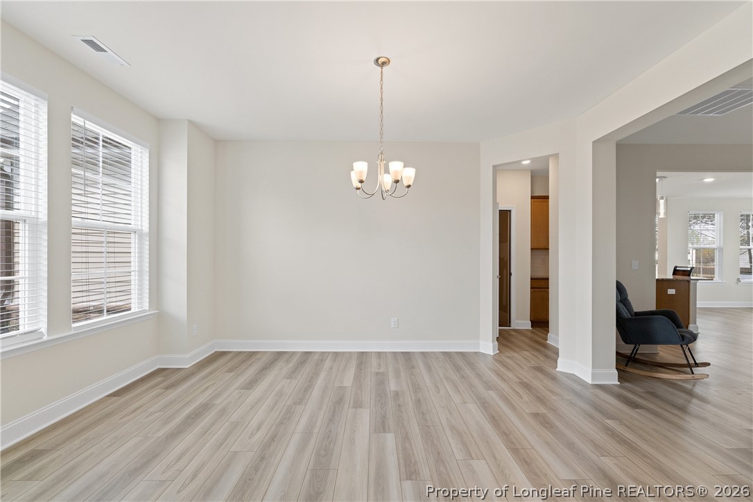 18 Two Belles Court Angier, NC 27501 - Photo 4 of 39 a view of a room with wooden floor and a window