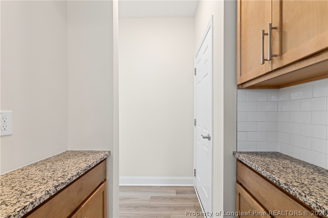 18 Two Belles Court Angier, NC 27501 - Photo 6 of 39 a utility room with granite countertop cabinets and utility room