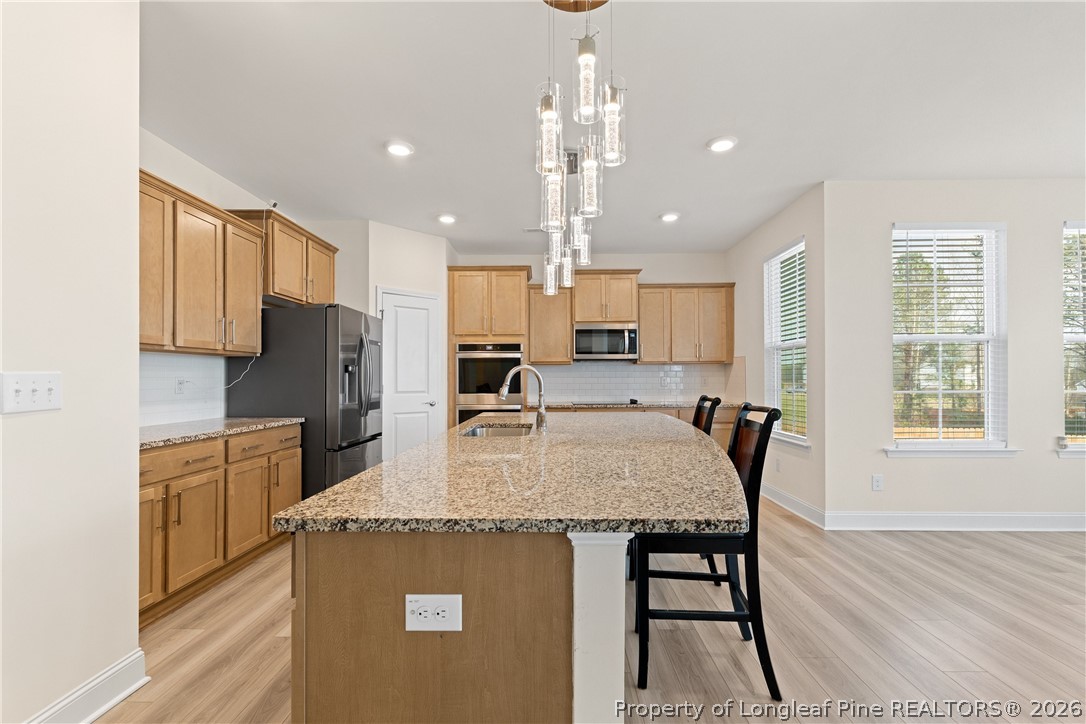 18 Two Belles Court Angier, NC 27501 - Photo 7 of 39 a large kitchen with kitchen island a large island in it
