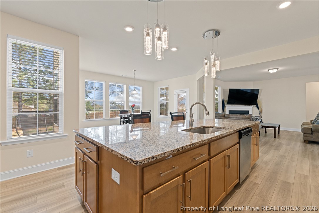 18 Two Belles Court Angier, NC 27501 - Photo 8 of 39 a very nice looking kitchen with granite countertop a large island in the center and stainless steel appliances