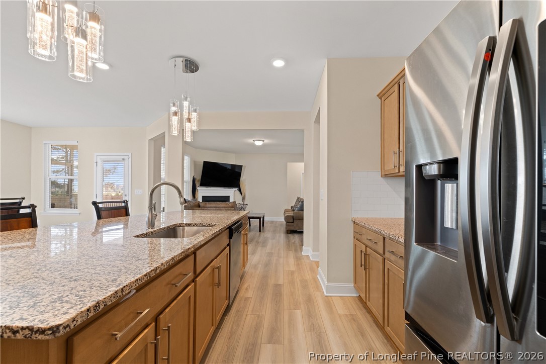 18 Two Belles Court Angier, NC 27501 - Photo 10 of 39 a kitchen with stainless steel appliances granite countertop a refrigerator a stove and a sink