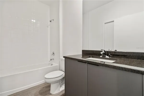a bathroom with a sink a toilet and a bathtub