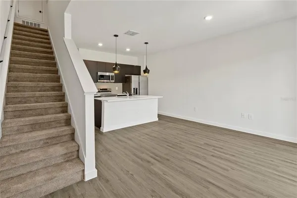 a view of kitchen with sink and wooden floor